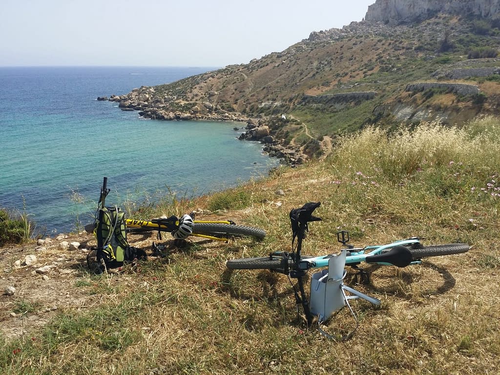 Bikes laying on the ground at Mgiebah bay Malta